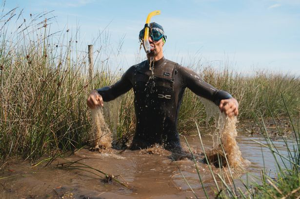 Muddy but victoriuos. Neil Rutter, a school teacher from Bath as been named the five time Bog Snorkelling World Champion