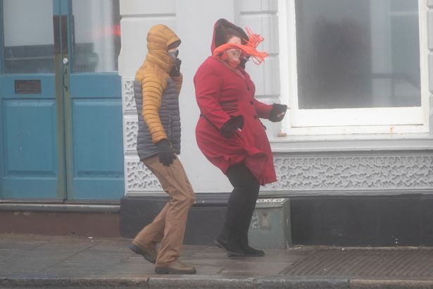 Members of the public are seen braving the stormy weather on January 1, 2025 in Brighton, England