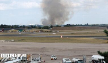 Huge plume of smoke pictured in the far distance of the airport.