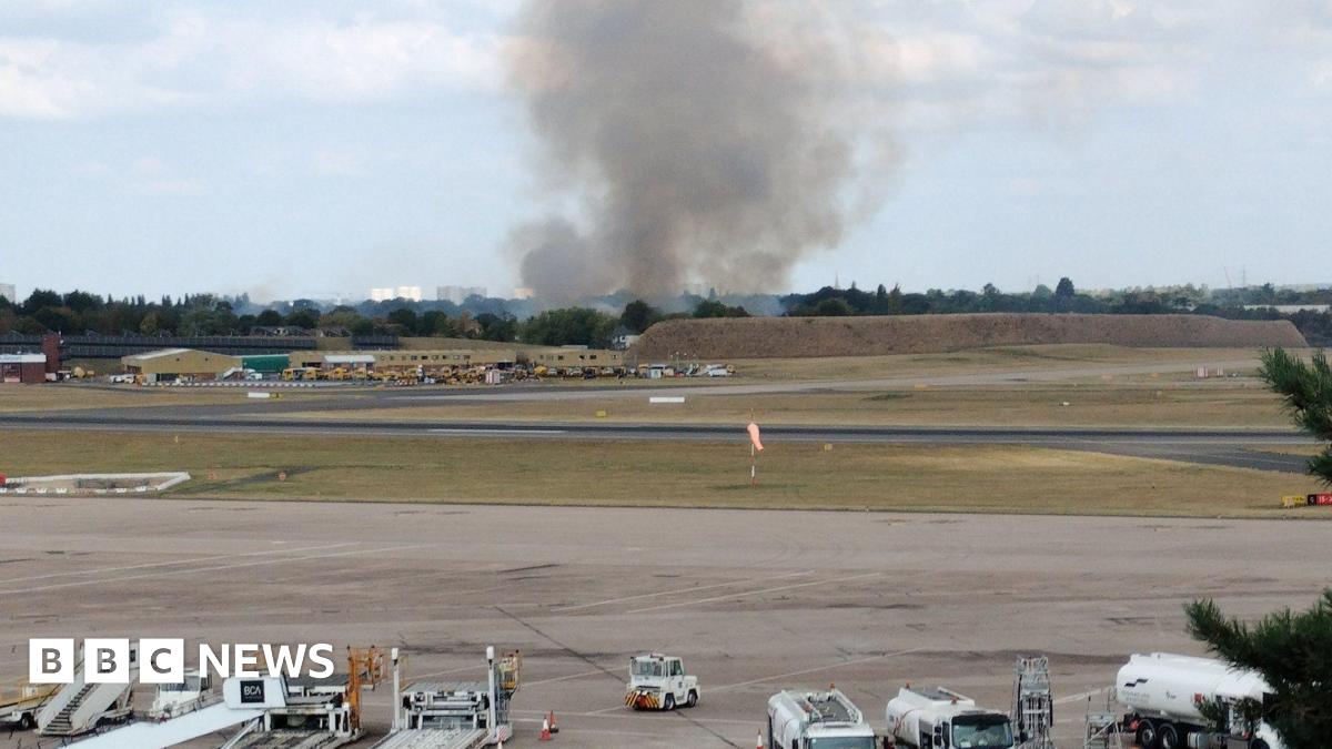 Huge plume of smoke pictured in the far distance of the airport.