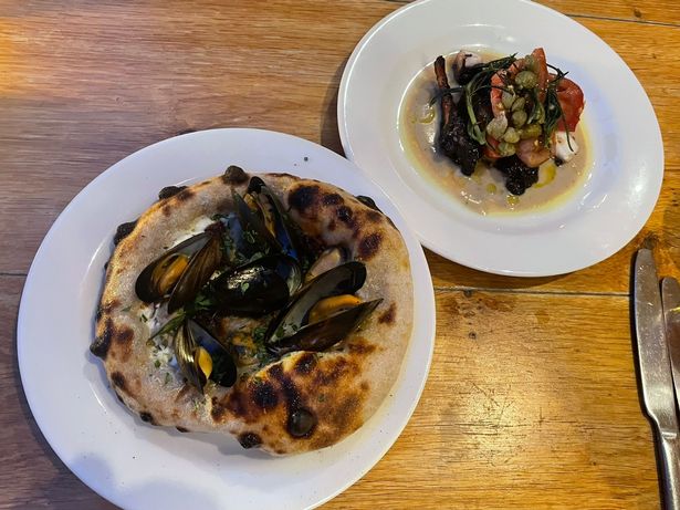Pictured is charcoal grilled octopus (back) and wood fired n'duja and mussel sourdough flatbread