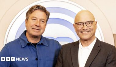Designed image showing headshots of Gregg Wallace and John Torode. Wallace is on the left, he has a shaved head, black rimmed glasses and is wearing a white open-necked shirt with grey jacket. Torode has short greying hair, a white open-necked shirt and grey jacket.