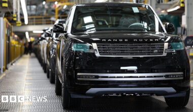 A line of Range Rovers on a production line in a UK factory