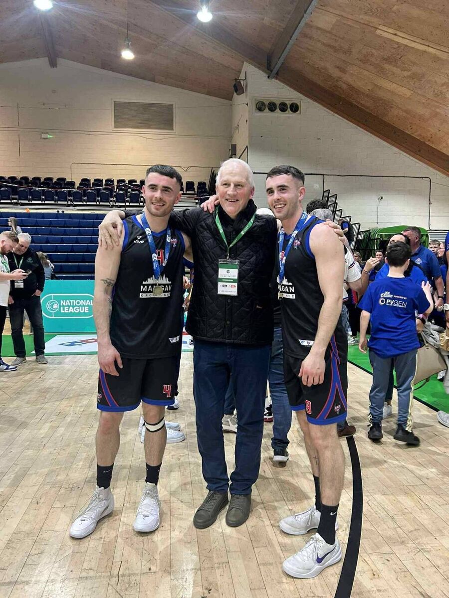 Scott Hannigan and his twin brother James with Blue Demons legend Tim McCarthy after winning the men’s National League title last season.