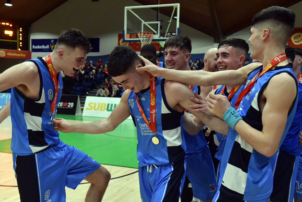 Neptune's Scott Hannigan is congratulated by teammates on winning the MVP award , after defeating Dublin Lions in the Hula Hoops under 20 Men's National cup final at the National basketball arena, Tallaght.