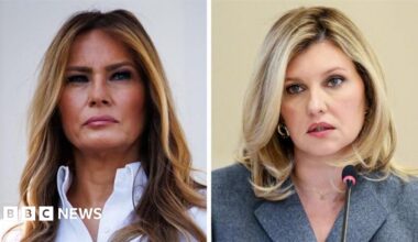 A side by side image of Melania Trump with a straight face, her light hair long, wearing a white shirt, beside Olena Zelenska, her expression neutral and hair blonde, wearing a grey jacket