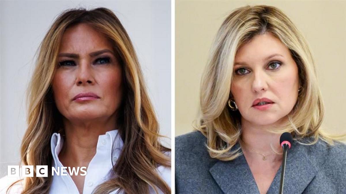 A side by side image of Melania Trump with a straight face, her light hair long, wearing a white shirt, beside Olena Zelenska, her expression neutral and hair blonde, wearing a grey jacket