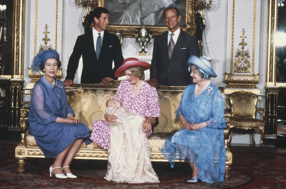Princess Diana wears a pink floral dress and pink hat to hold Prince William on August 4, 1982 at his royal christening