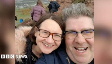Sandra O'Hagan and David Burgess are both smiling while pictured outdoors and wearing coats in this selfie.