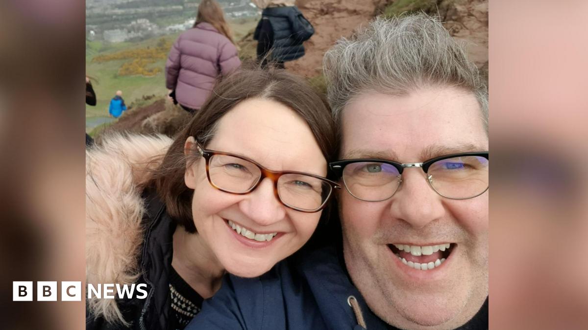 Sandra O'Hagan and David Burgess are both smiling while pictured outdoors and wearing coats in this selfie.