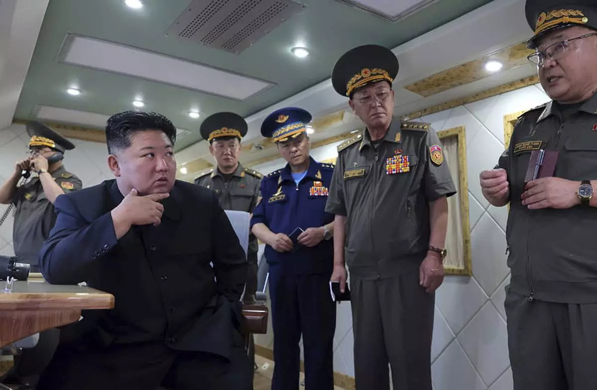 ADDS DATE - In this photo provided Sunday, Aug. 24, 2025, by the North Korean government, North Korean leader Kim Jong Un, left, supervises the test-firing of two types of new anti-air missiles at undisclosed location, North Korea on Aug. 23, 2025. Independent journalists were not given access to cover the event depicted in this image distributed by the North Korean government. The content of this image is as provided and cannot be independently verified. (Korean Central News Agency/Korea News Service via AP)