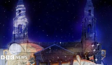 A light display projected to the walls of Leeds Civic Hall. The night sky is filled with stars.