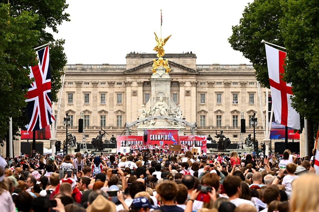 view of the stage at Buckingham Palace surrounded by crowd of people