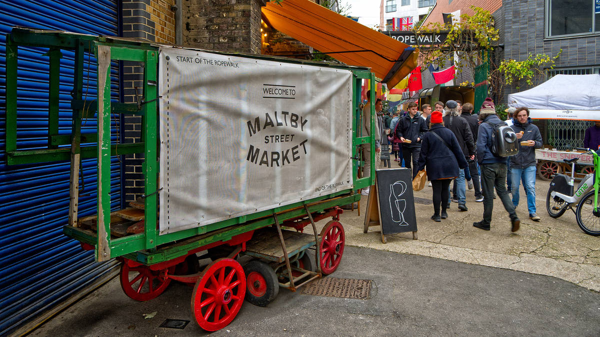 a sign for maltby street market at the entrance to the market