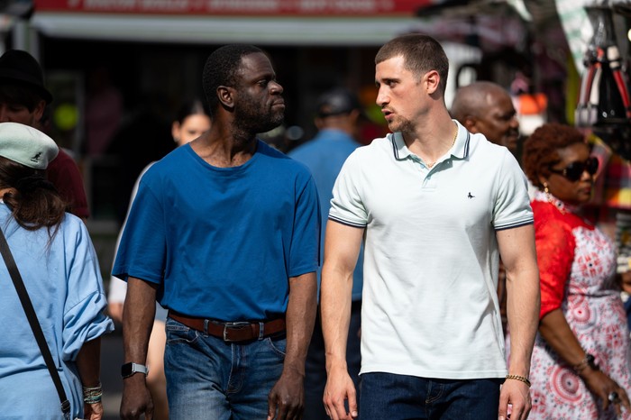 Kojo and Harry walking together in EastEnders