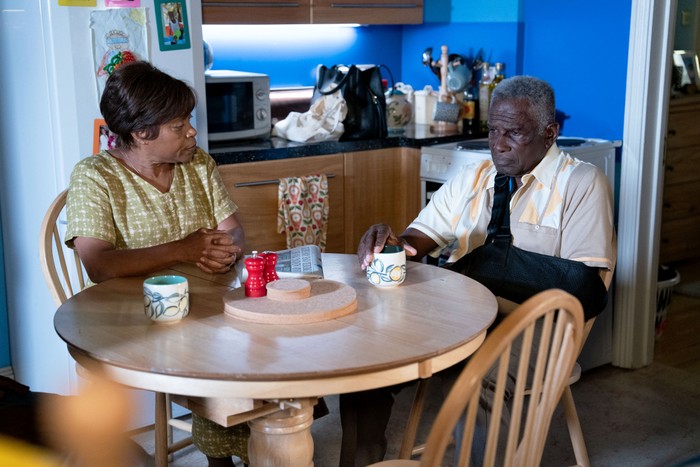 Yolande sitting with an uneasy Patrick in EastEnders