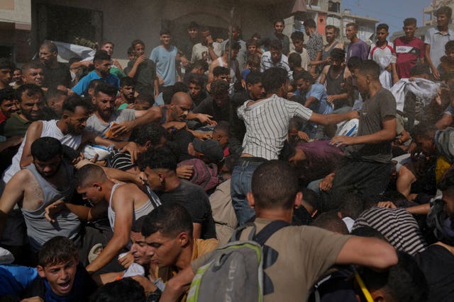 Palestinians struggle to collect humanitarian aid airdropped into Gaza City