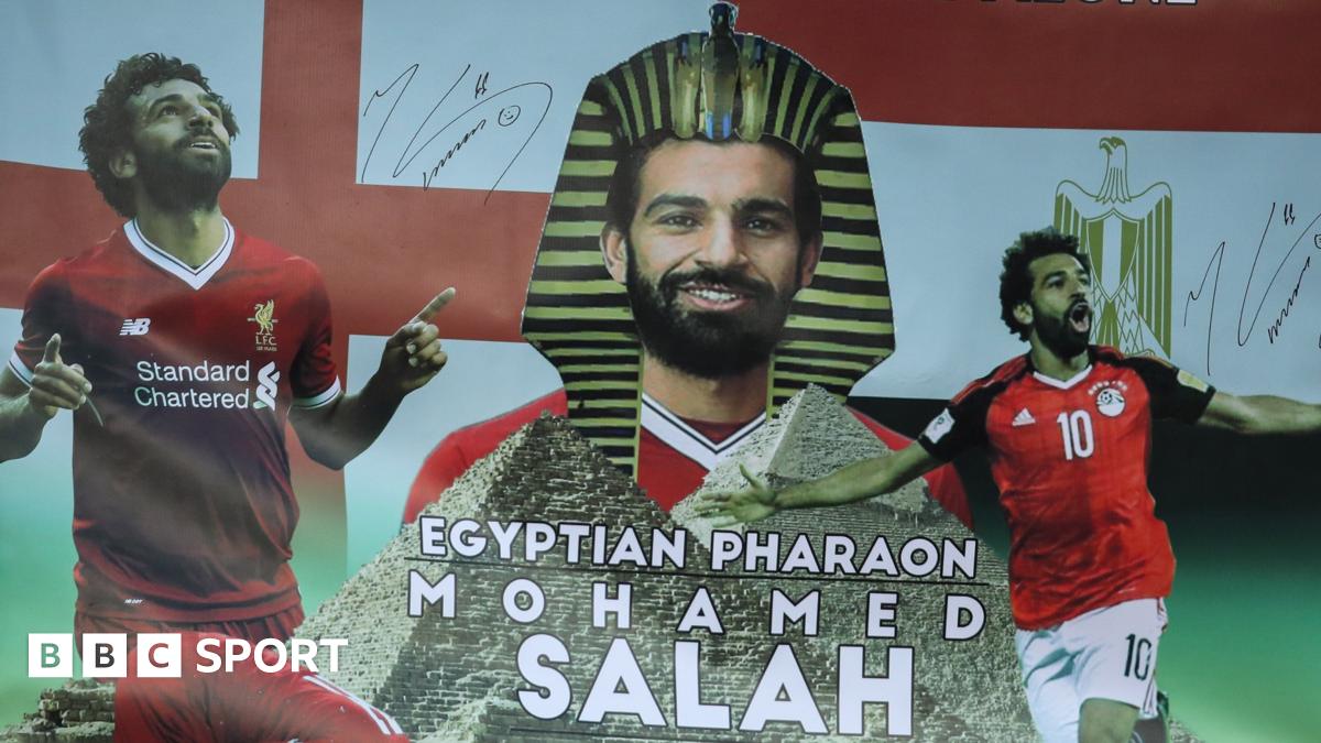 Egypt fans at the 2019 Africa Cup of Nations hold up a banner showing the face of forward Mohamed Salah