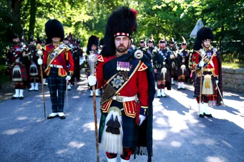 PA Media The pipe band of 3 & 4 SCOTS, Royal Regiment of Scotland as King Charles III carries out an inspection of the Balaklava Company, 5th Battalion, The Royal Regiment of Scotland, at the gates of Balmoral, as he takes up summer residence at the castle. 