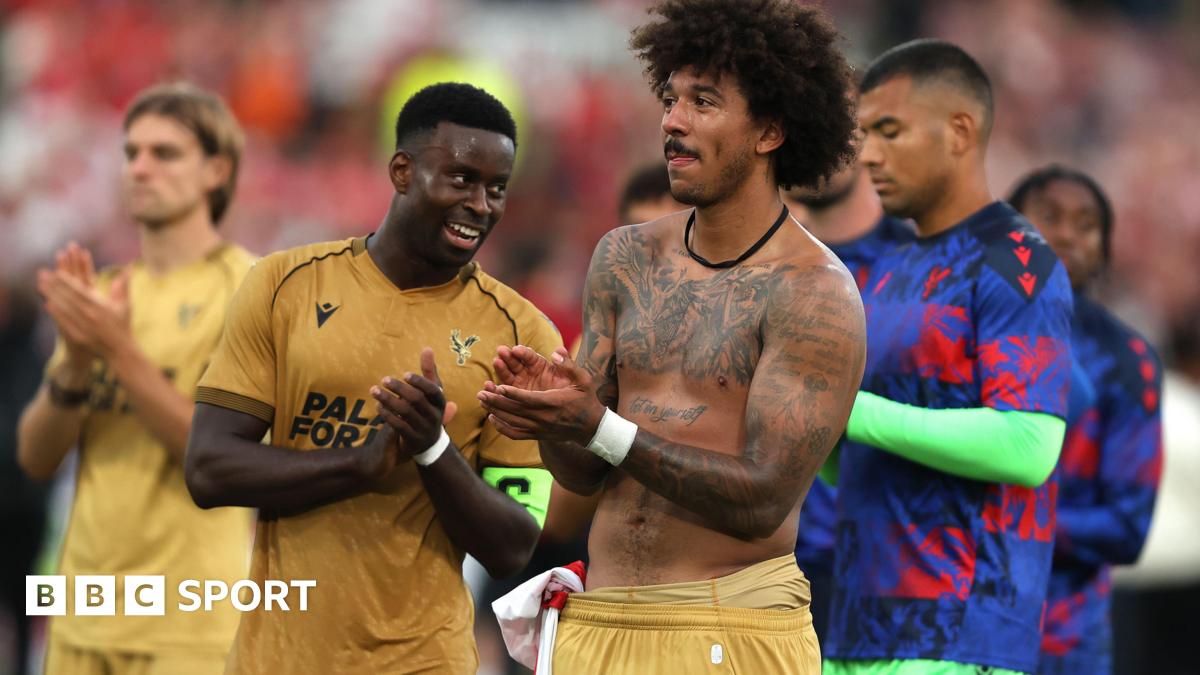 Marc Guehi and Chris Richards applaud the Crystal Palace fans