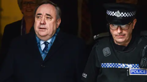 Getty Images Former Scottish First Minister Alex Salmond departs Edinburgh High Court on March 23, 2020 in Edinburgh, Scotland. Alex Salmond has been cleared of sexual assaulting nine women while he was Scotland's first minister. The jury found the former SNP leader not guilty on 12 of the sexual assault charges facing him, while another was found not proven, a further charge of sexually assaulting a 10th woman had previously been dropped by prosecutors. 