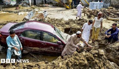 People struggle to retrieve a car from mud and debris after flash floods in the Buner district of the monsoon-hit northern Pakistani province of Khyber Pakhtunkhwa, on 16 August 2025.