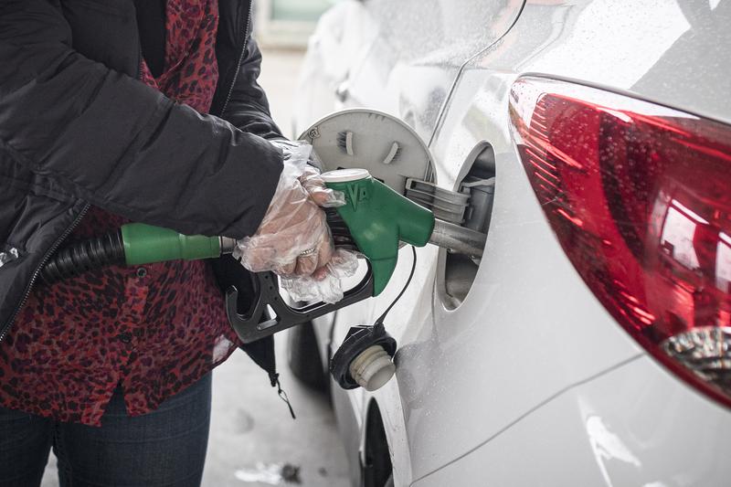 A person filling up a car’s fuel tank