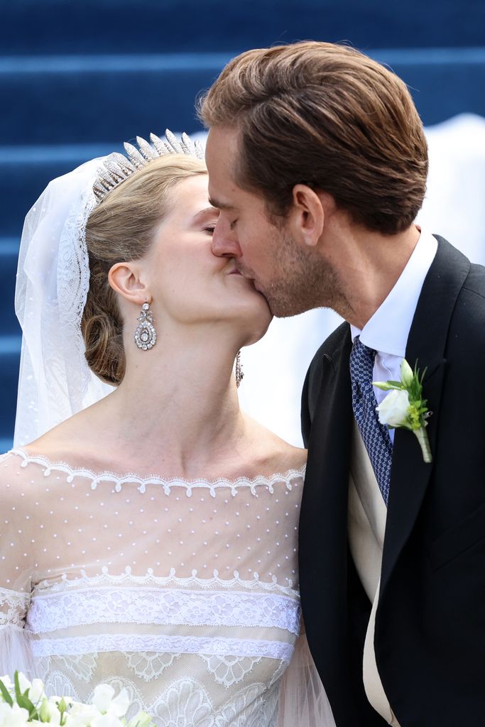 Princess Marie Caroline of Liechtenstein and Mr. Leopoldo Maduro Vollmer  kiss outside of their wedding