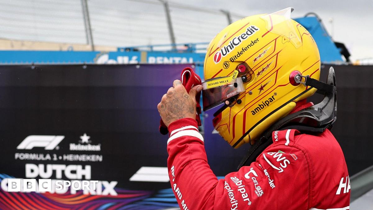 Lewis Hamilton adjusts his helmet visor after retiring form the Dutch Grand Prix