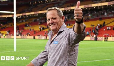 Kevin Walters gives a thumbs up to fans while doing a lap of honour of the pitch at Suncorp Stadium after Brisbane Broncos beat Manly Sea Eagles in the NRL.