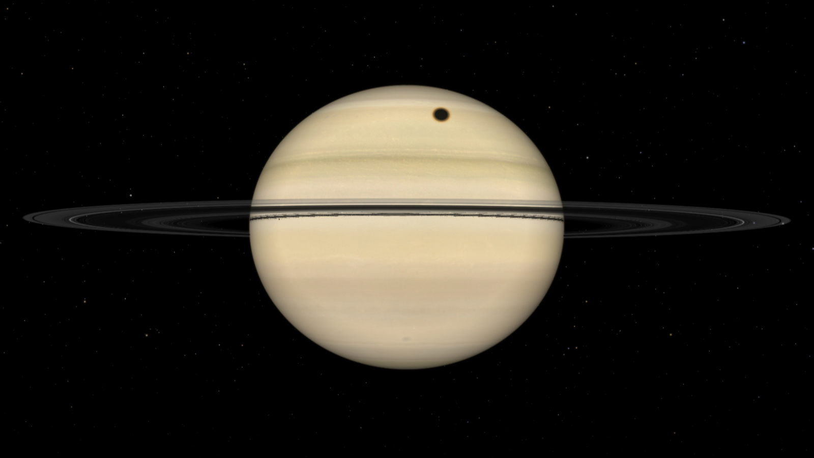 A simulation of the gas giant Saturn fully illuminated by direct sunlight. The planet's sweeping rings are positioned almost edge on to the observer, and a dark circular shadow is visible on the banded cloud surface above the ring line.