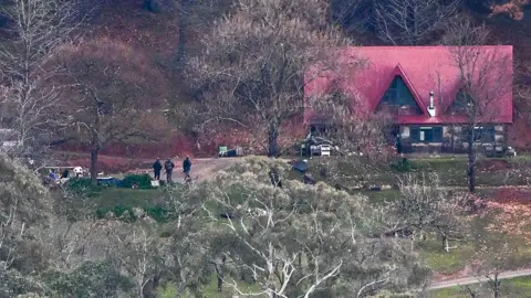 Getty Images A red roofed house is seen between trees on the property in Porepunkah