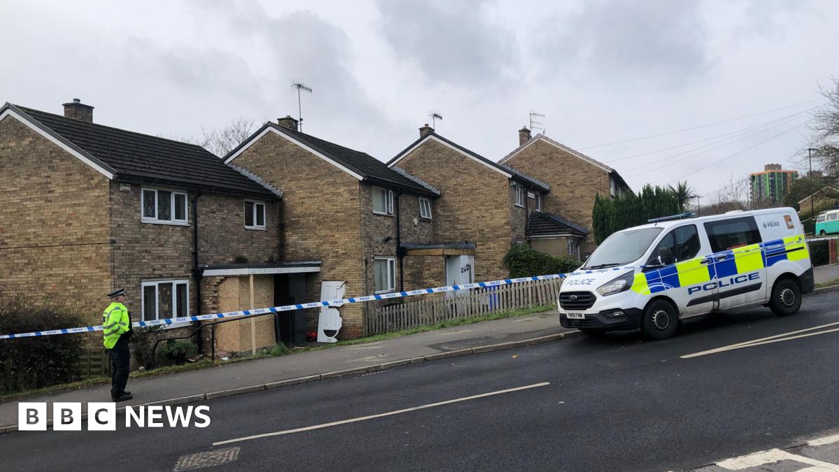 Police cordon outside damaged property