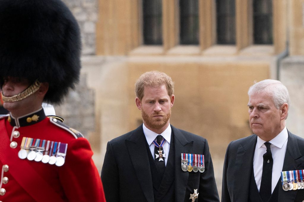Britain's Prince Harry, Duke of Sussex (L) talks with Britain's Prince Andrew, Duke of York as they arrive at St George's Chapel in 2022