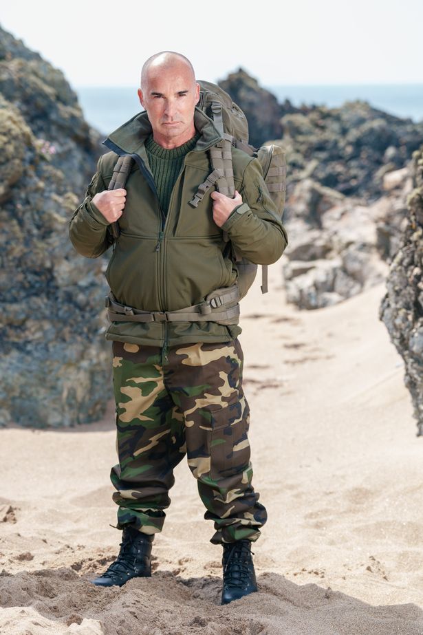 Standing shot of Louis Spence on beach, wearing bergen