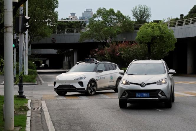 A driverless Apollo Go taxi from Baidu (left) on a road in Wuhan, China, on July 19, 2024.