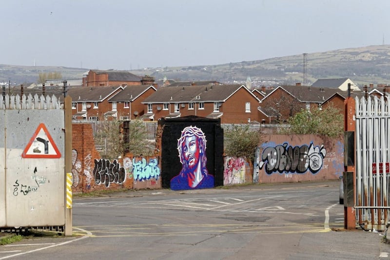 Street artist Glen Molloy paints a picture of Jesus on the Peaceline near Cupar Way, it is done in the style of the iconic "Hope" image of Barack Obama designed by artist Shepard Fairey Picture Mal McCann. 