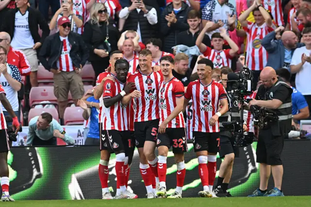 Daniel Ballard (C) celebrates