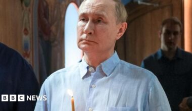 Russian President Vladimir Putin holds a candle during a service at the Valaam Monastery in north-western Russia. Photo: 1 August 2025