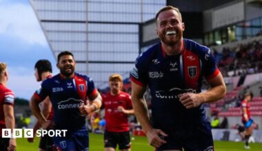 Hull Kingston Rovers winger Joe Burgess celebrates a try against Salford Red Devils with teammate Peta Hiku