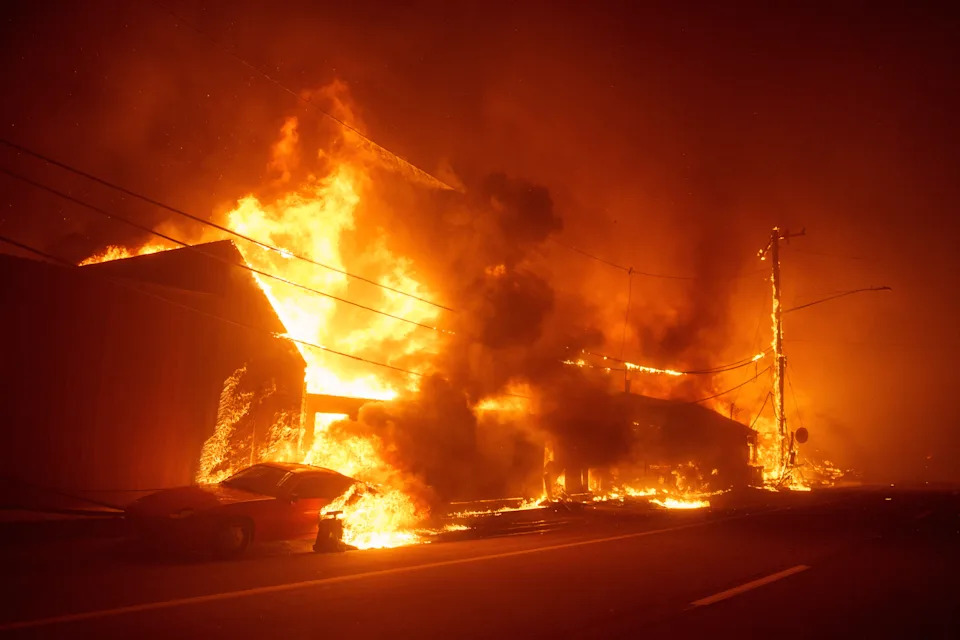 Flames from the Palisades Fire burn homes along Pacific Coast Highway on January 7, 2025 in Malibu, California.