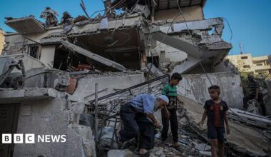People inspect the damage on a house in Gaza City on August 20, 2025.