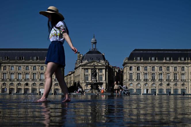 A woman cools off in Bordeaux on August 8, 2025, as a heatwave spreads across the south of France.