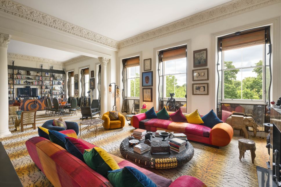 A wide view of Pauline Karpidas’s London salon, featuring eclectic furniture, art-filled walls.