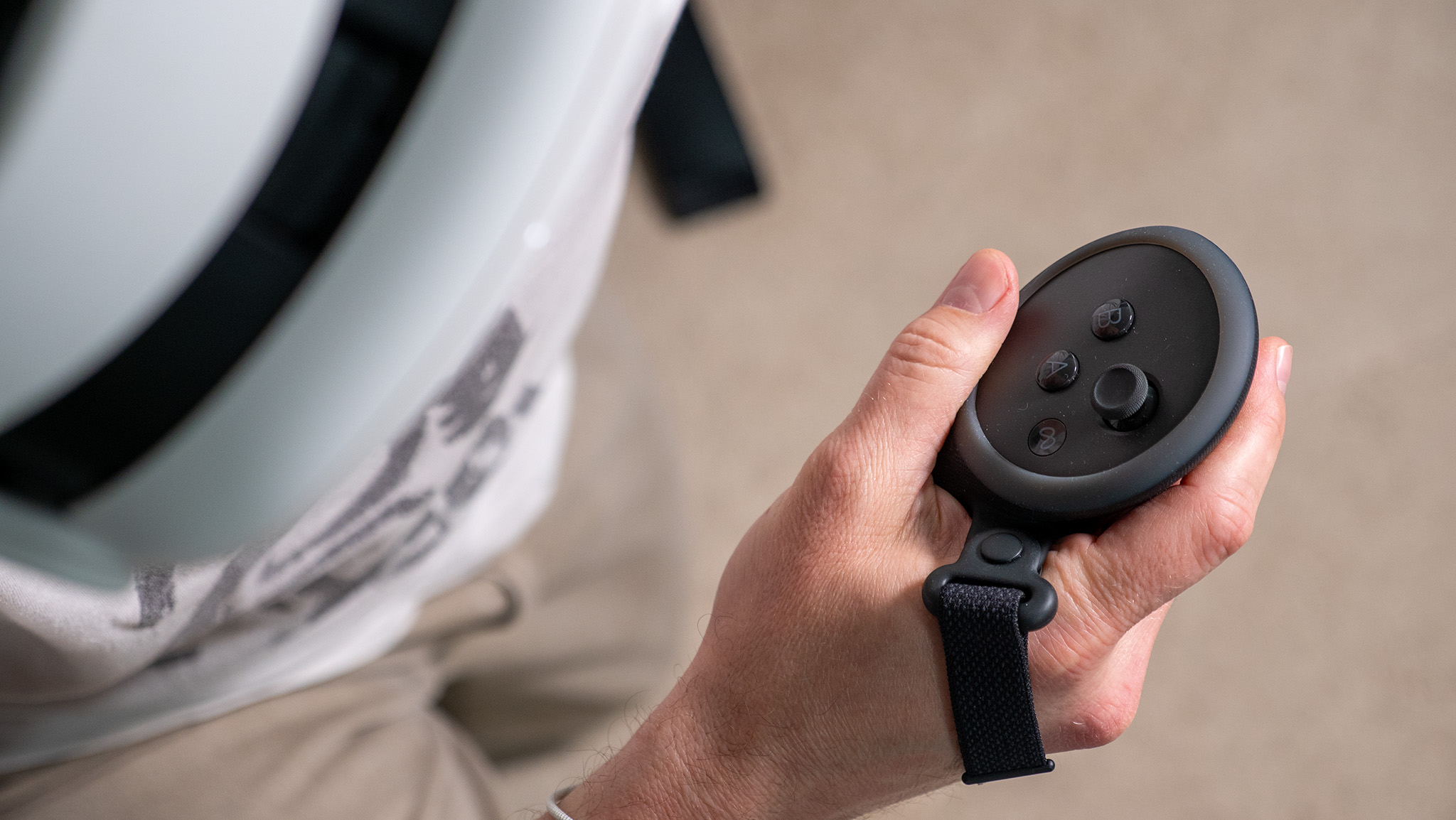 Holding a Meta Quest 3 controller while playing