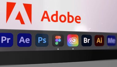 Close-up of a computer screen showing the Adobe logo and name, with various Adobe and design application icons, including Premiere Pro, After Effects, Photoshop, Figma, Creative Cloud, Bridge, Illustrator, and Media Encoder, in the dock below.