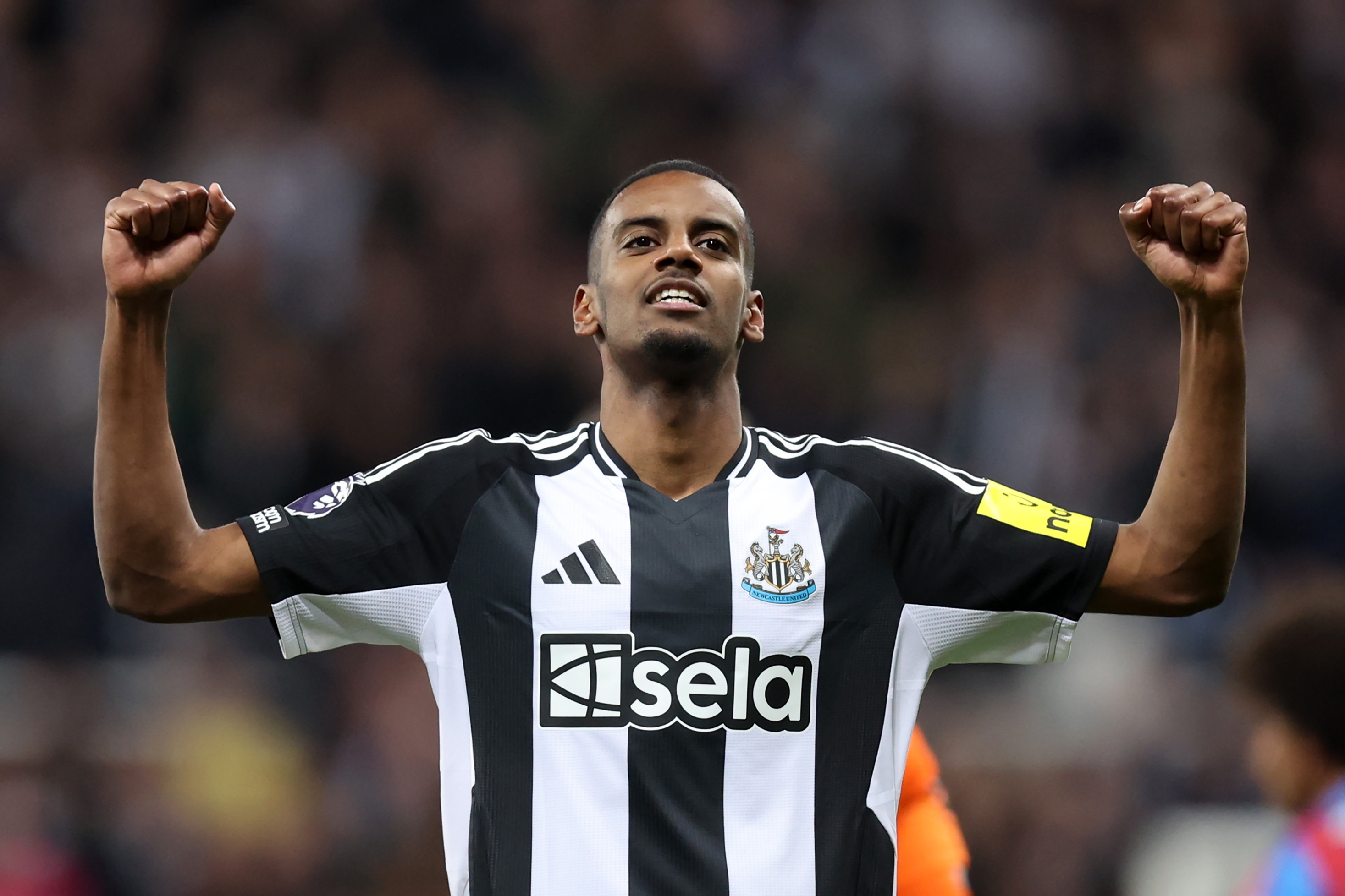 Alexander Isak holds his arms out wide whilst playing for Newcastle.