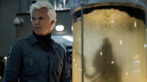 'Alien: Earth' stars Timothy Olyphant as Kirsh, shown here standing near a container with an alien inside