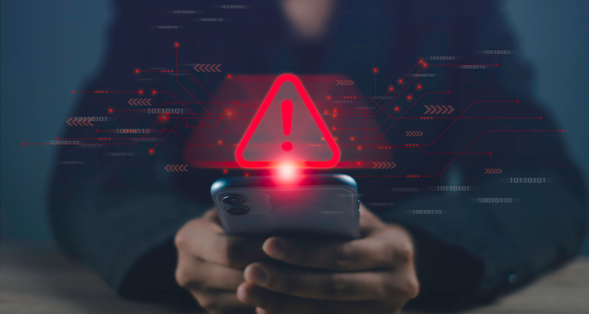 A person looking at a phone with a digital warning sign over it