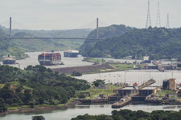 A cargo ship navigates through the Panama Canal, seen from the Cerro Ancon in Panama City